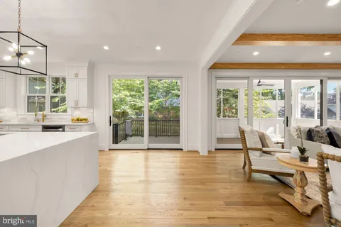 a bedroom with furniture and a large window