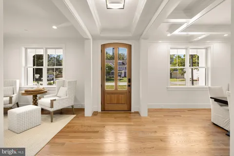 a living room with fireplace a flat screen tv and wooden floor