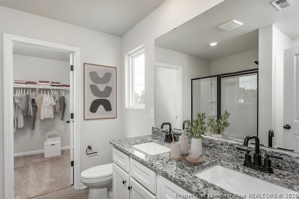 28 Rider Street Broadway, NC 27505 - Photo 21 of 22 a bathroom with a granite countertop sink a toilet and shower