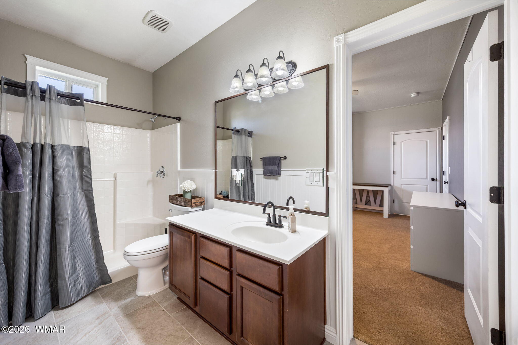 1940 Stonegate Way Heber, AZ 85928 - Photo 37 of 62 a spacious bathroom with a sink a toilet a mirror and shower view
