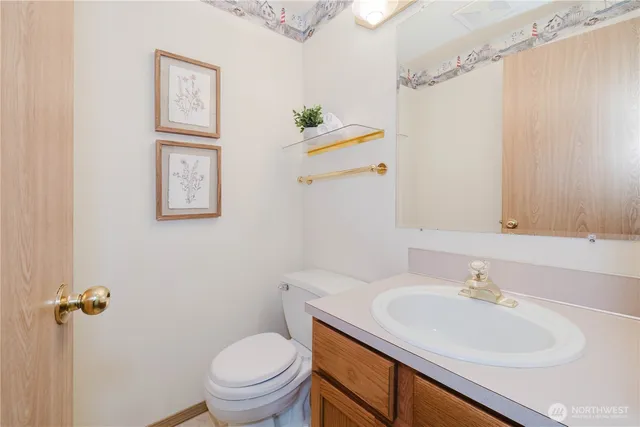 a bathroom with a sink a toilet and a mirror