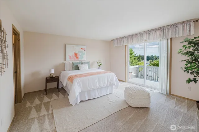 a bedroom with a large bed and a potted plant