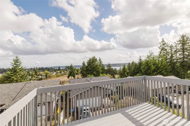 a balcony with wooden floor and fence