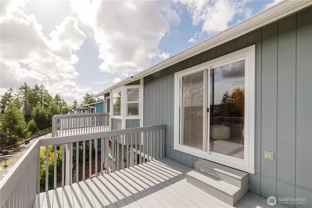 a view of a wooden deck and a yard