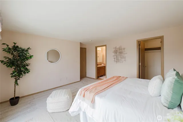 a bedroom with a bed and a potted plant