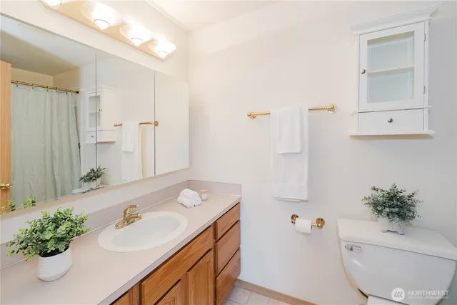 a bathroom with a sink a toilet and a mirror