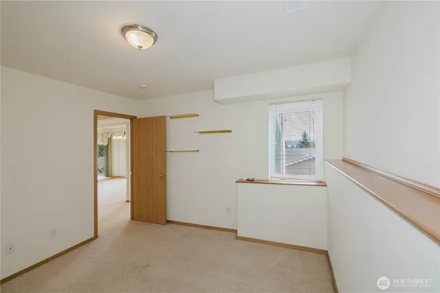 an empty room with windows and closet