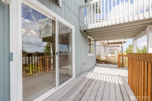 a view of a balcony with wooden floor