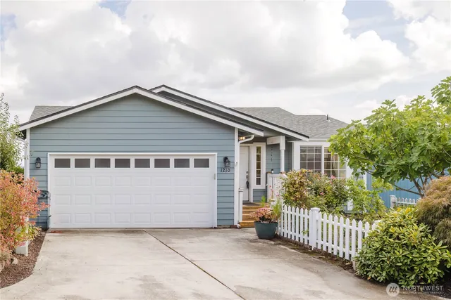 a view of a house with wooden fence