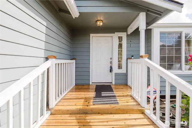 a view of balcony with wooden floor and fence
