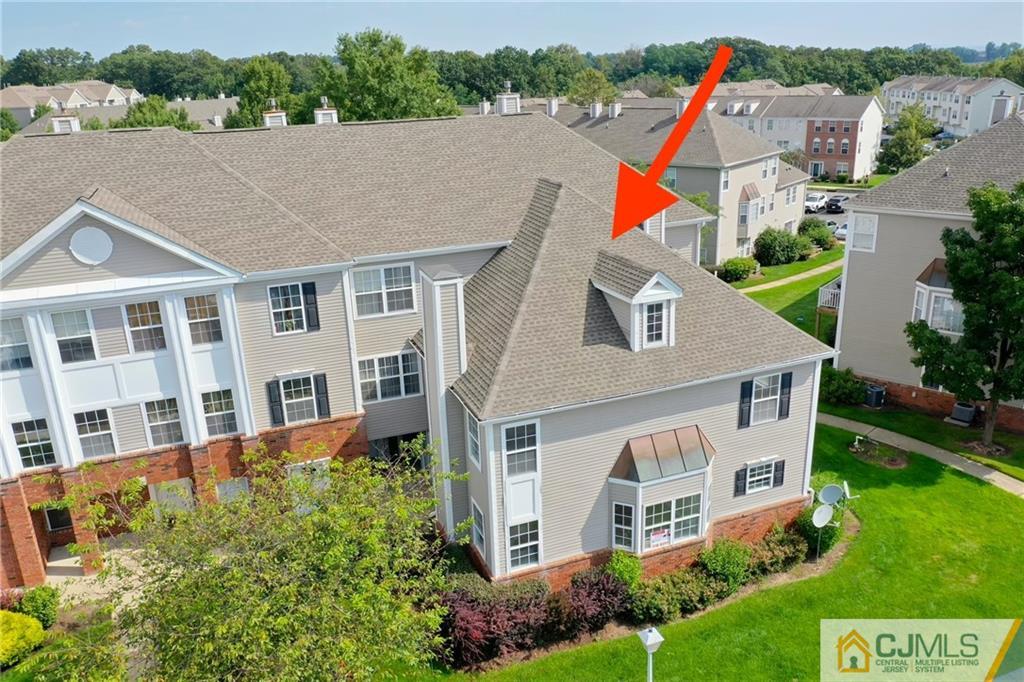 an aerial view of a house with a yard and potted plants