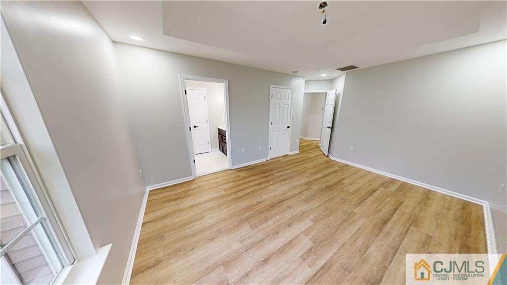 2405 Timber Ridge Court, Unit 2405 Sayreville, NJ 08859 - Photo 14 of 29 a view of a big room with wooden floor and windows