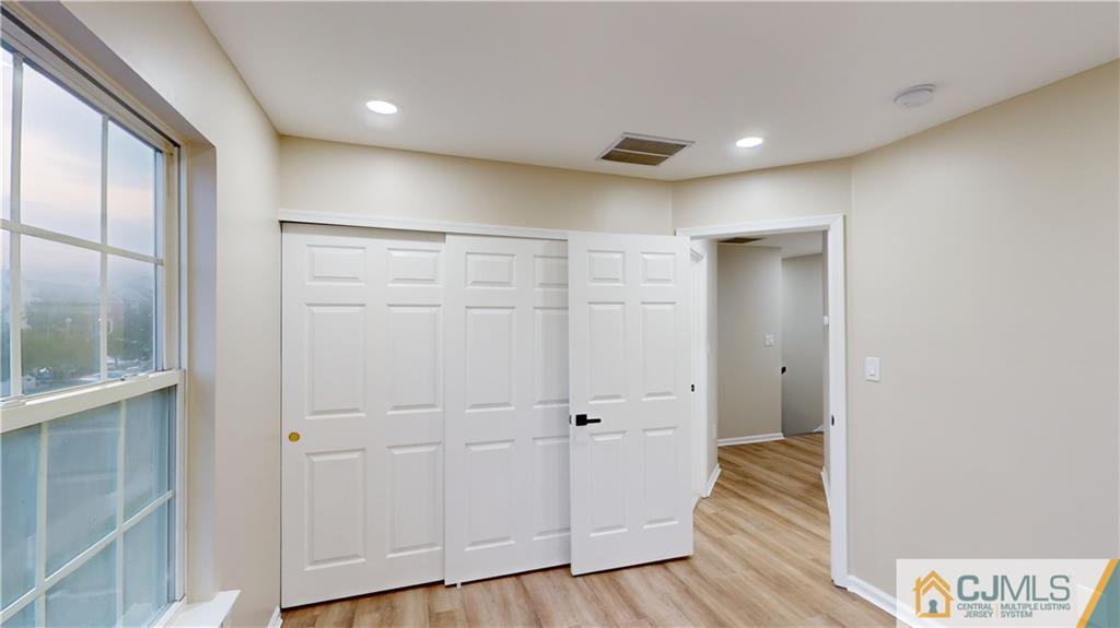 2405 Timber Ridge Court, Unit 2405 Sayreville, NJ 08859 - Photo 20 of 29 a view of empty room with wooden floor