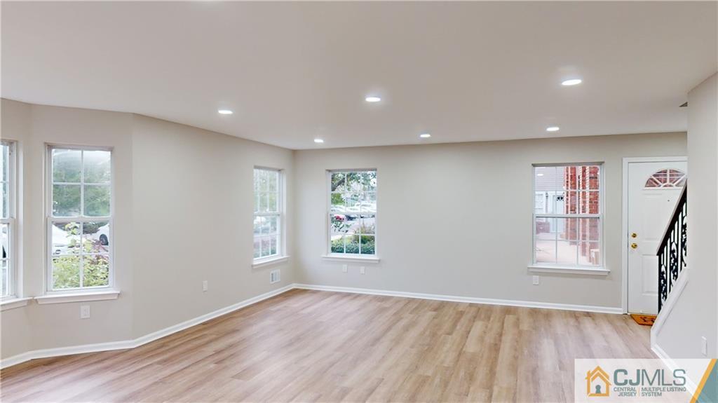 2405 Timber Ridge Court, Unit 2405 Sayreville, NJ 08859 - Photo 2 of 29 a view of an empty room with wooden floor and a window