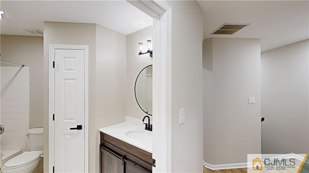 2405 Timber Ridge Court, Unit 2405 Sayreville, NJ 08859 - Photo 21 of 29 a bathroom with a sink a toilet and shower