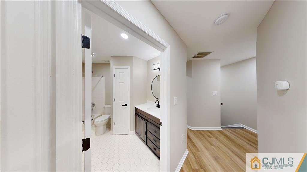 2405 Timber Ridge Court, Unit 2405 Sayreville, NJ 08859 - Photo 22 of 29 a bathroom with a double vanity sink mirror and shower