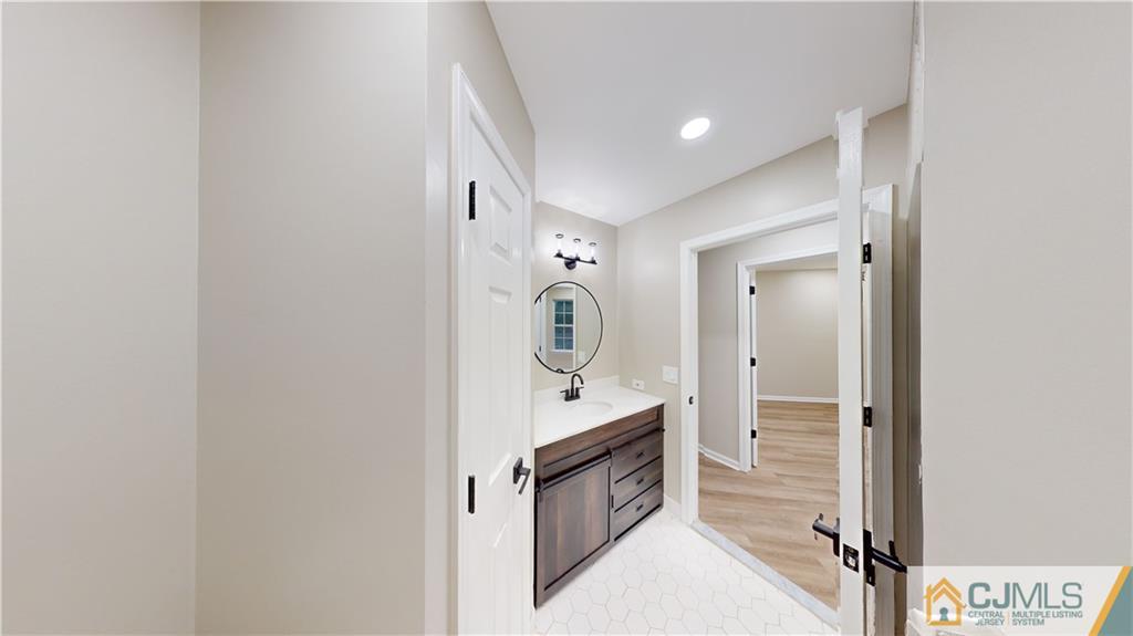 2405 Timber Ridge Court, Unit 2405 Sayreville, NJ 08859 - Photo 23 of 29 a bathroom with a sink a mirror and a shower