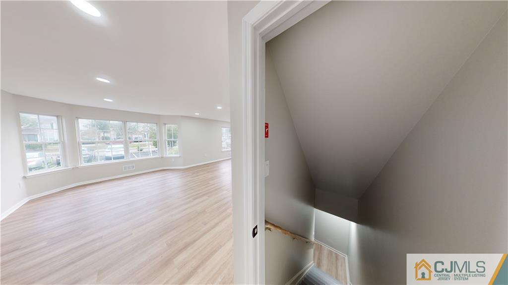 2405 Timber Ridge Court, Unit 2405 Sayreville, NJ 08859 - Photo 24 of 29 a view of an empty room with wooden floor and a window