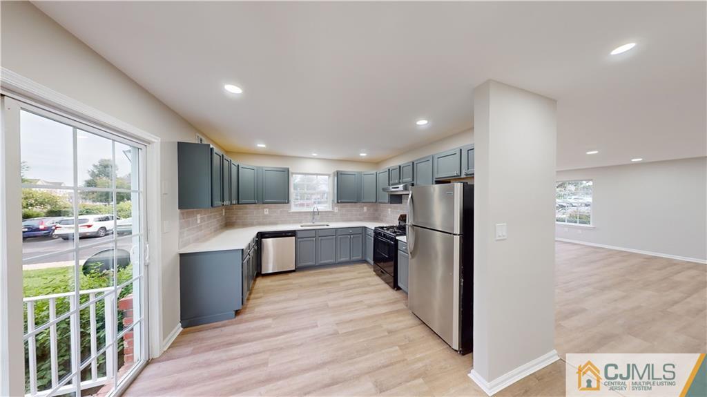 2405 Timber Ridge Court, Unit 2405 Sayreville, NJ 08859 - Photo 5 of 29 a kitchen with stainless steel appliances granite countertop a refrigerator and a stove top oven
