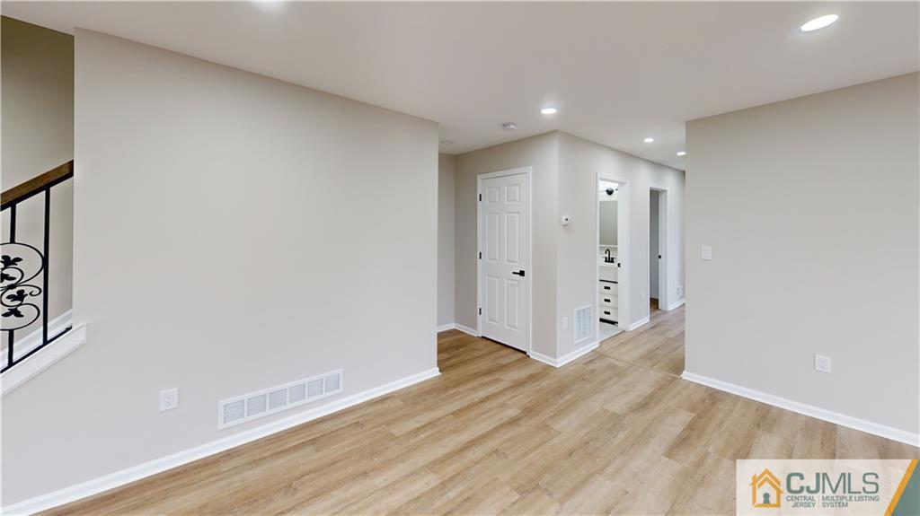 2405 Timber Ridge Court, Unit 2405 Sayreville, NJ 08859 - Photo 9 of 29 a view of a hallway with wooden floor