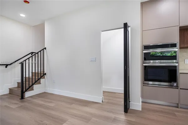 a view of kitchen with refrigerator and window