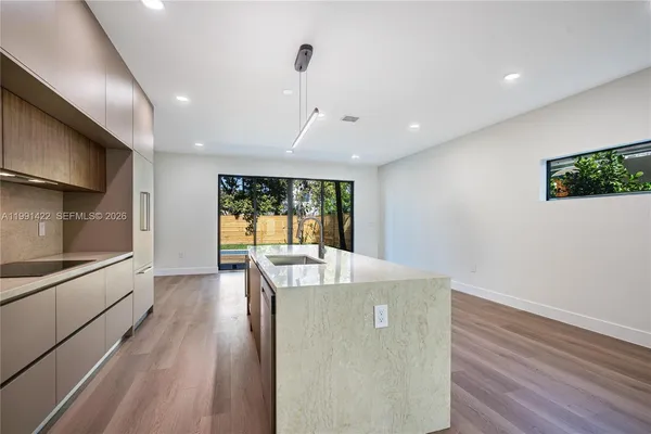 a kitchen with stainless steel appliances granite countertop a sink and stove