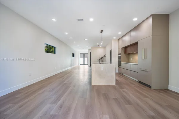 a kitchen with windows and refrigerator