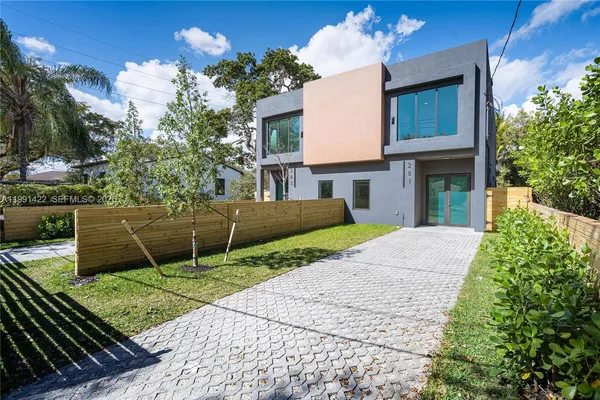 a view of a house with a yard and a garden