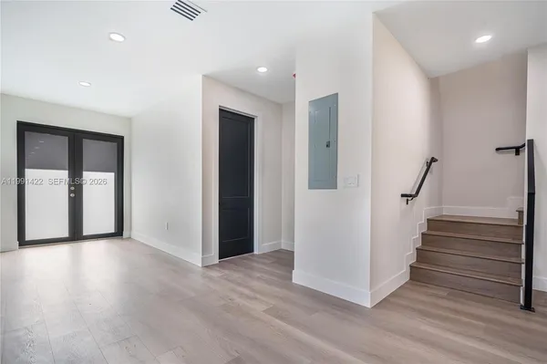 a view of empty room with wooden floor