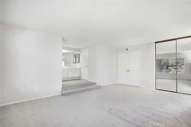 a bathroom with a double vanity sink and mirror
