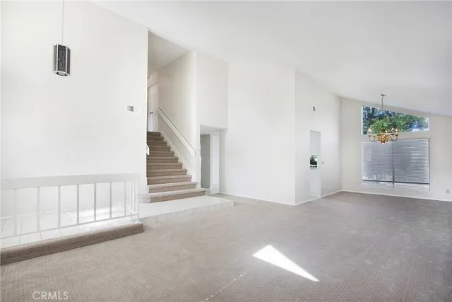 a view of an empty room with stairs