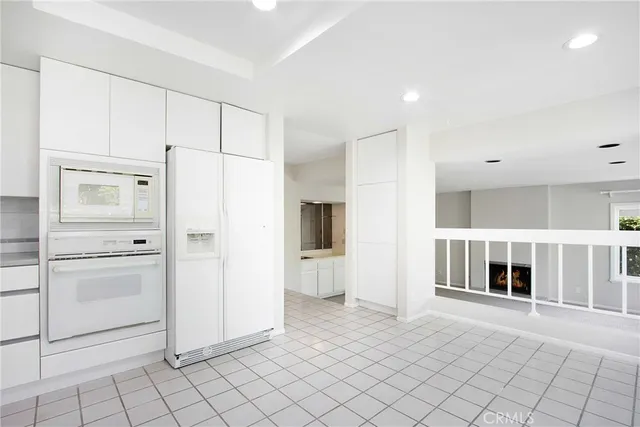 a view of kitchen with furniture and refrigerator