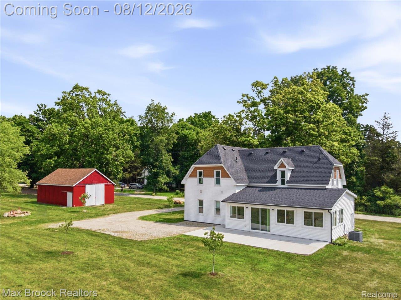 4217 Bricker Road Avoca, MI 48006 - Photo 48 of 69 Charming farmhouse property featuring a classic white Colonial exterior with gabled roofline, multiple windows with dark shutters, and a wraparound foundation
