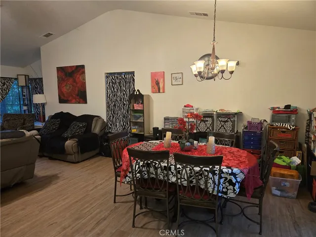 a view of a dining room with furniture wooden floor and chandelier