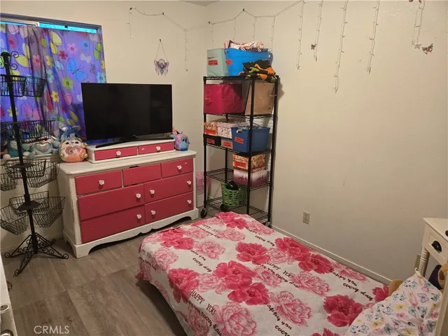 a bedroom with a bed and flat screen tv