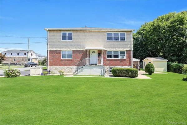 a front view of house with yard and green space