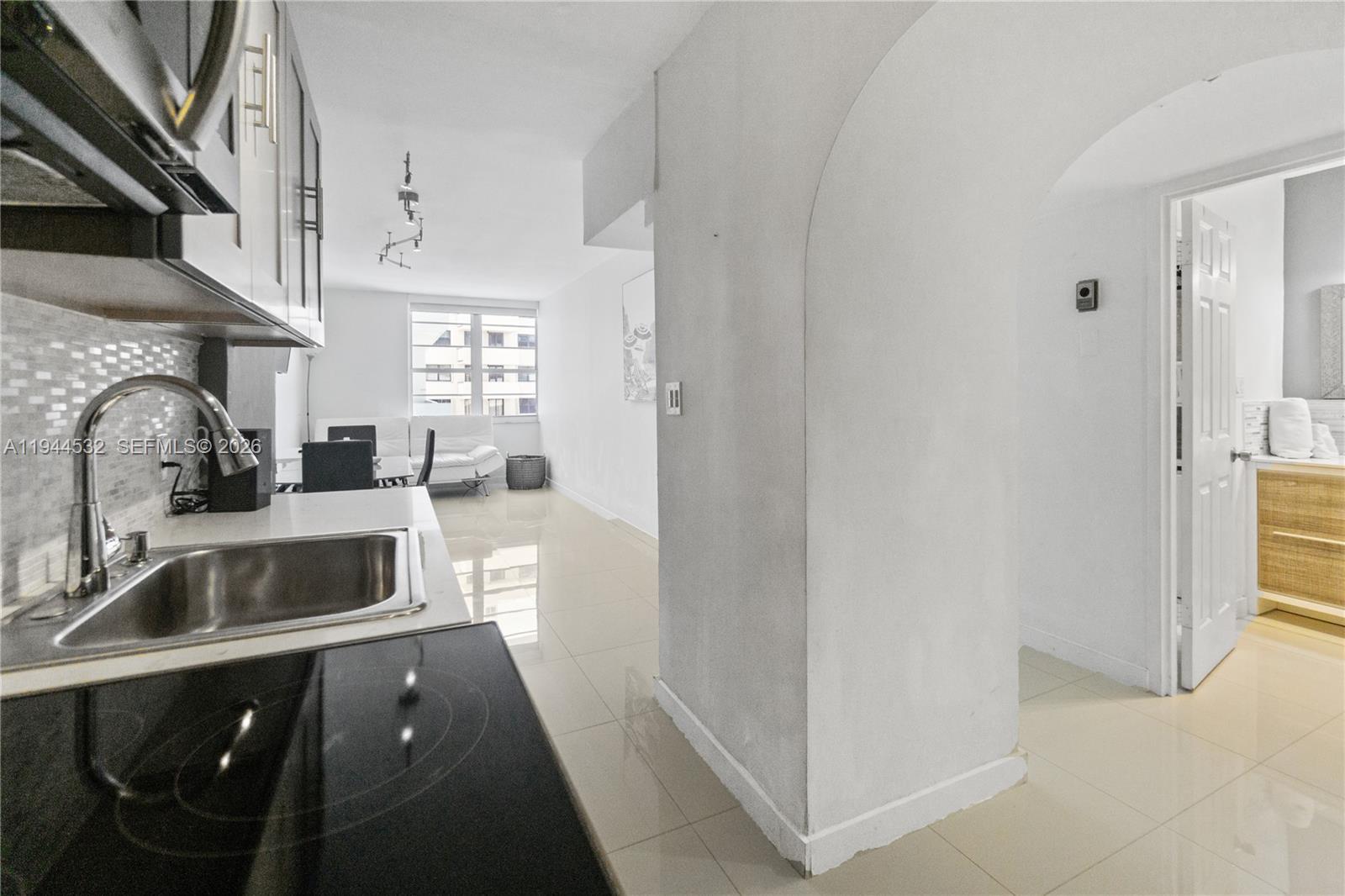 100 Lincoln Road, Unit 501 Miami Beach, FL 33139 - Photo 2 of 36 a kitchen with stainless steel appliances a sink and a refrigerator