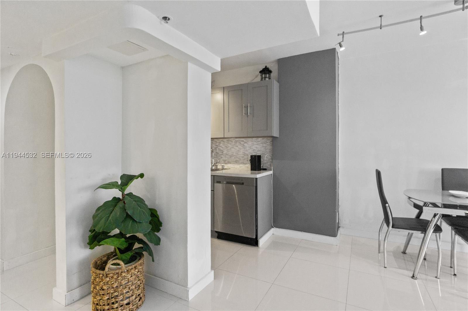 100 Lincoln Road, Unit 501 Miami Beach, FL 33139 - Photo 8 of 32 a white kitchen with a sink appliances and a counter top space
