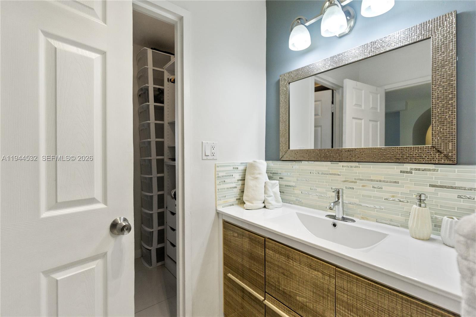 100 Lincoln Road, Unit 501 Miami Beach, FL 33139 - Photo 10 of 32 a bathroom with a double vanity sink and a mirror