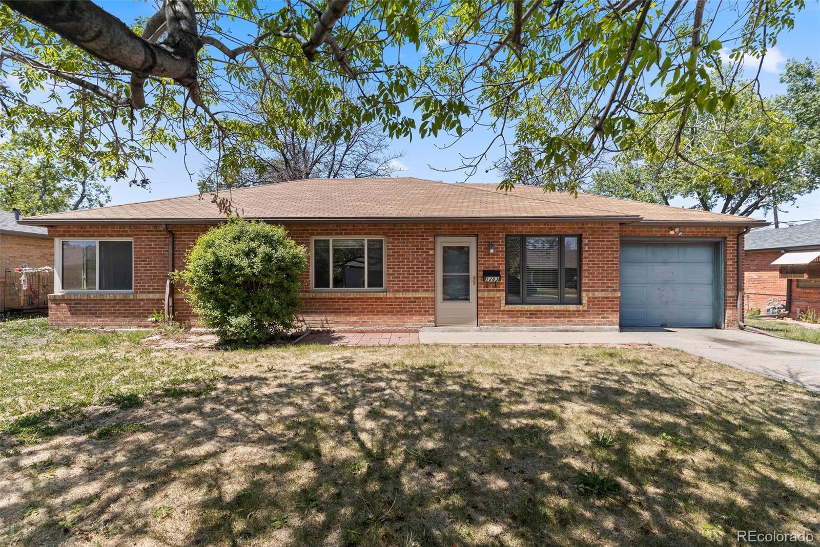 1283 Racine Street Aurora, CO 80011 - Photo 1 of 25 front view of a house with a tree