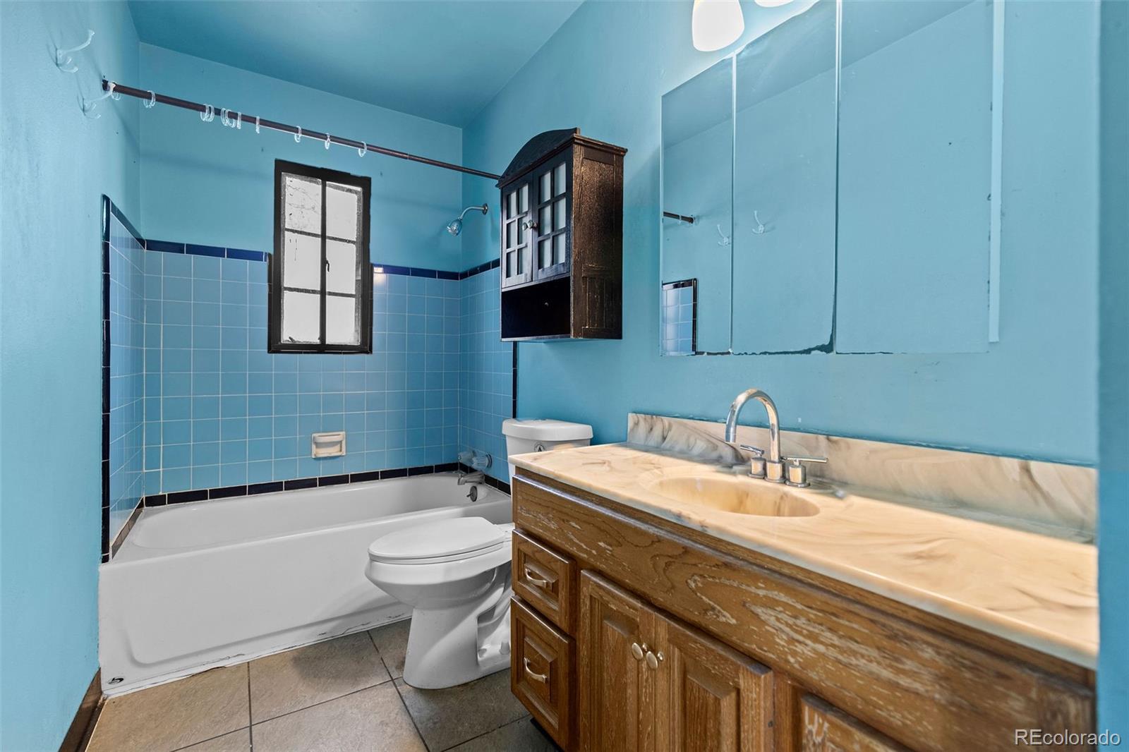 1283 Racine Street Aurora, CO 80011 - Photo 15 of 25 a bathroom with a sink a toilet and mirror