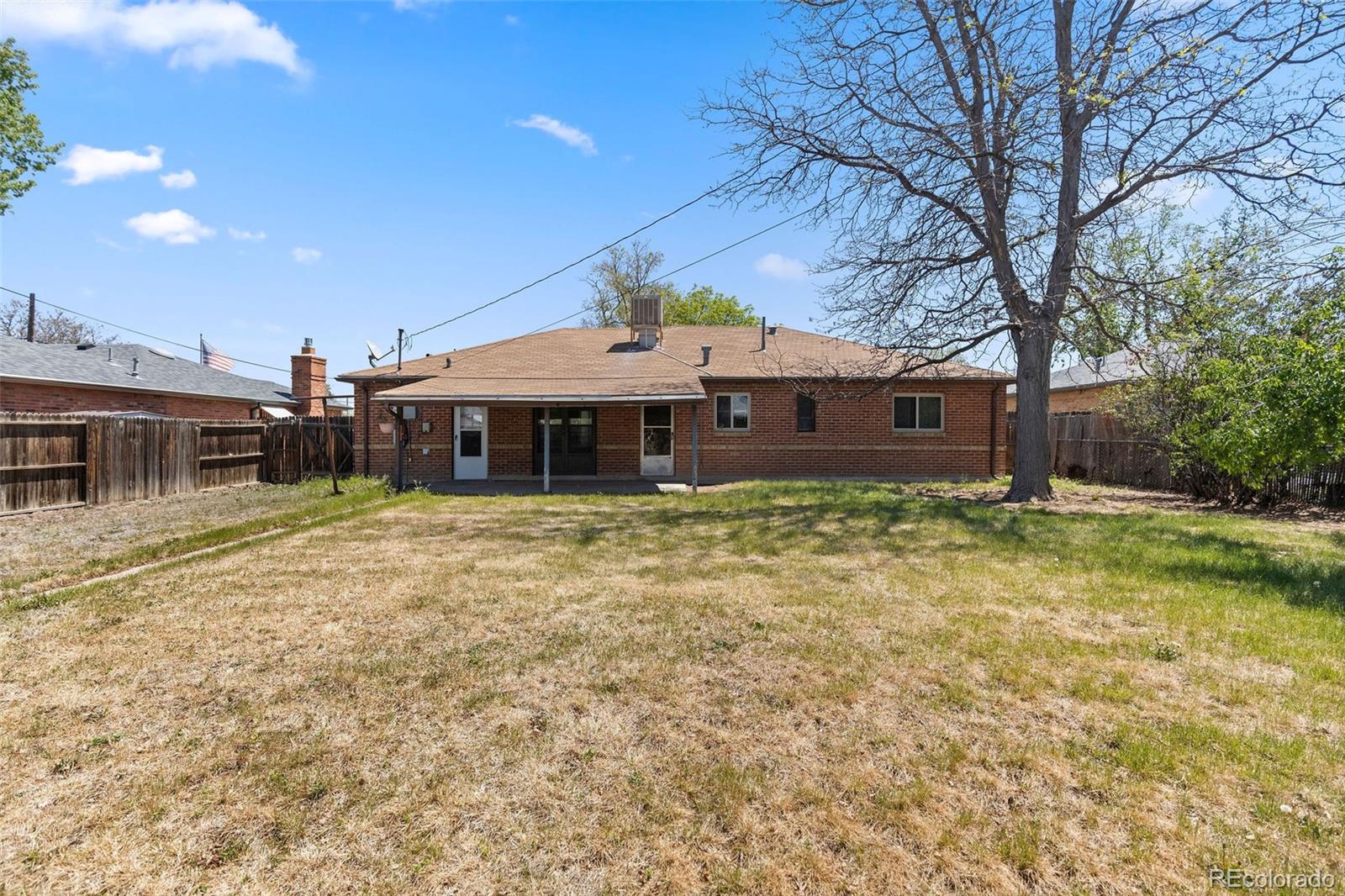 1283 Racine Street Aurora, CO 80011 - Photo 22 of 25 a front view of a house with a garden