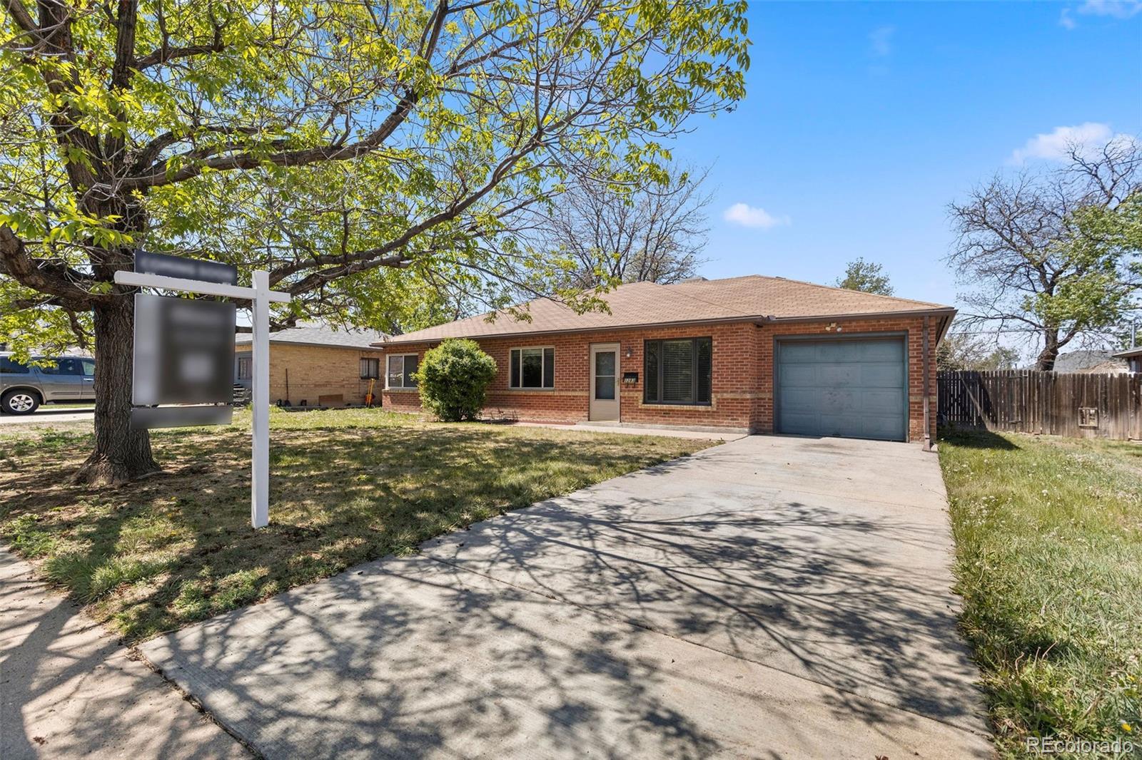 1283 Racine Street Aurora, CO 80011 - Photo 24 of 25 a front view of a house with a garden