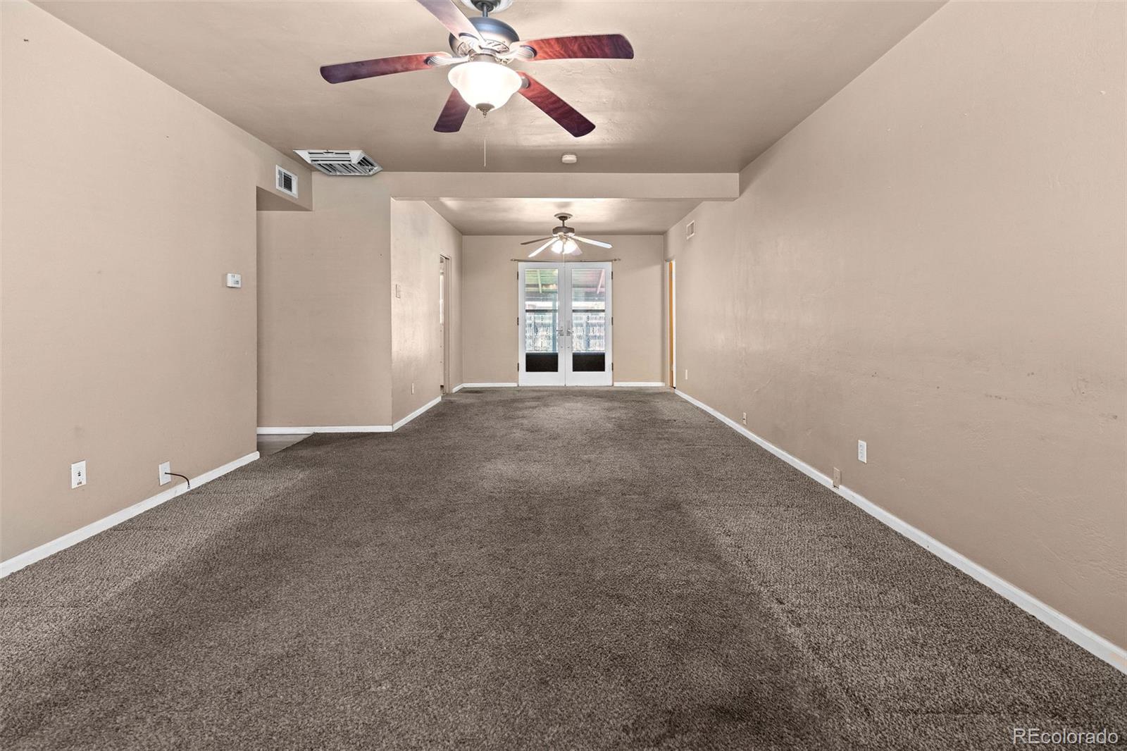 1283 Racine Street Aurora, CO 80011 - Photo 3 of 25 a view of an empty room with a window