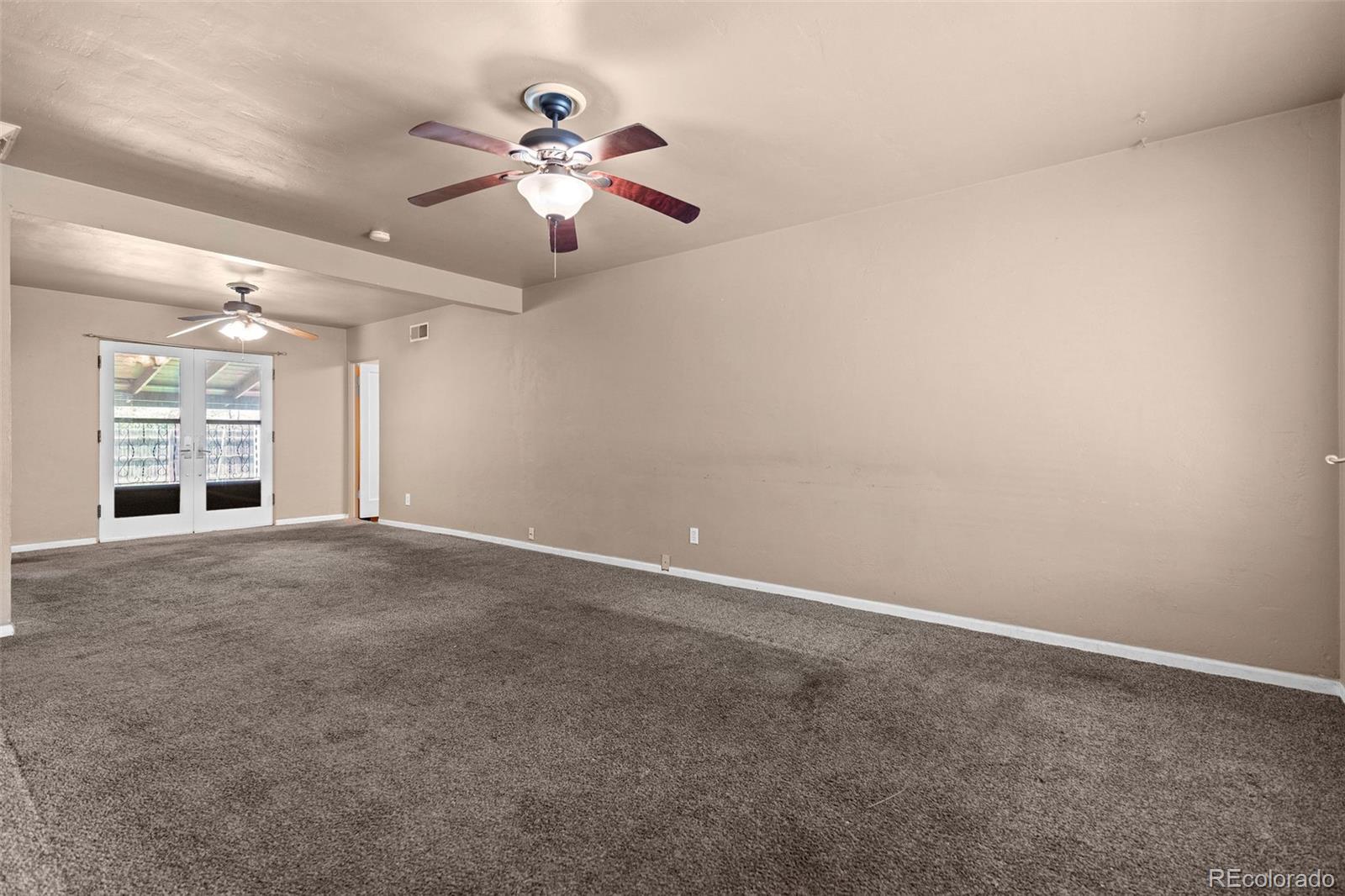 1283 Racine Street Aurora, CO 80011 - Photo 4 of 25 a view of an empty room with a window