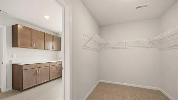 a storage & utility room with cabinets