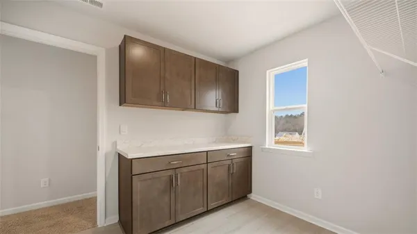 a room with a sink cabinets and utility room