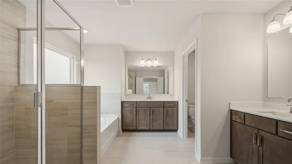 a bathroom with a double vanity sink a mirror and a shower