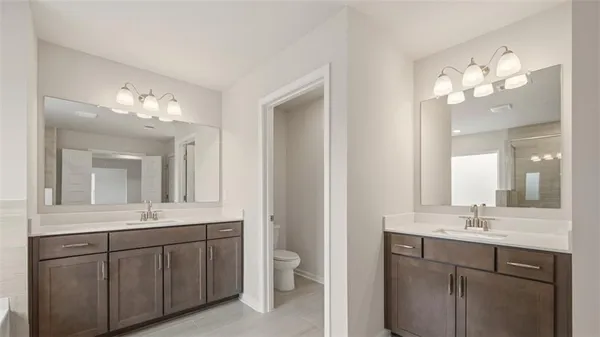 a bathroom with a double vanity sink and a mirror