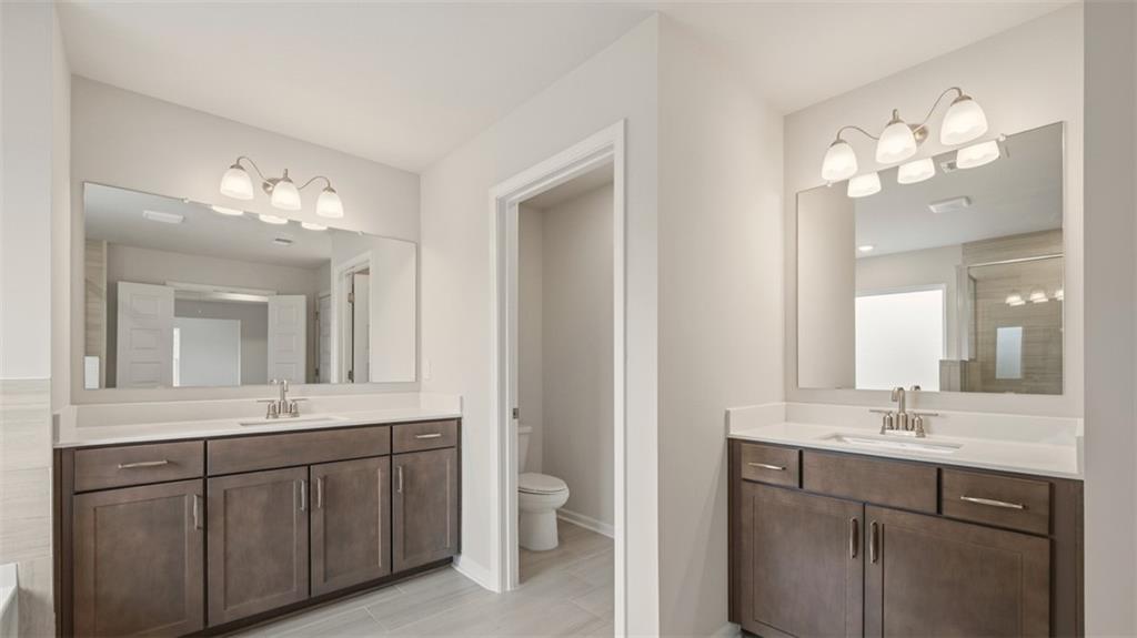 1908 Endress Circle Hampton, GA 30228 - Photo 34 of 35 a bathroom with a double vanity sink and a mirror